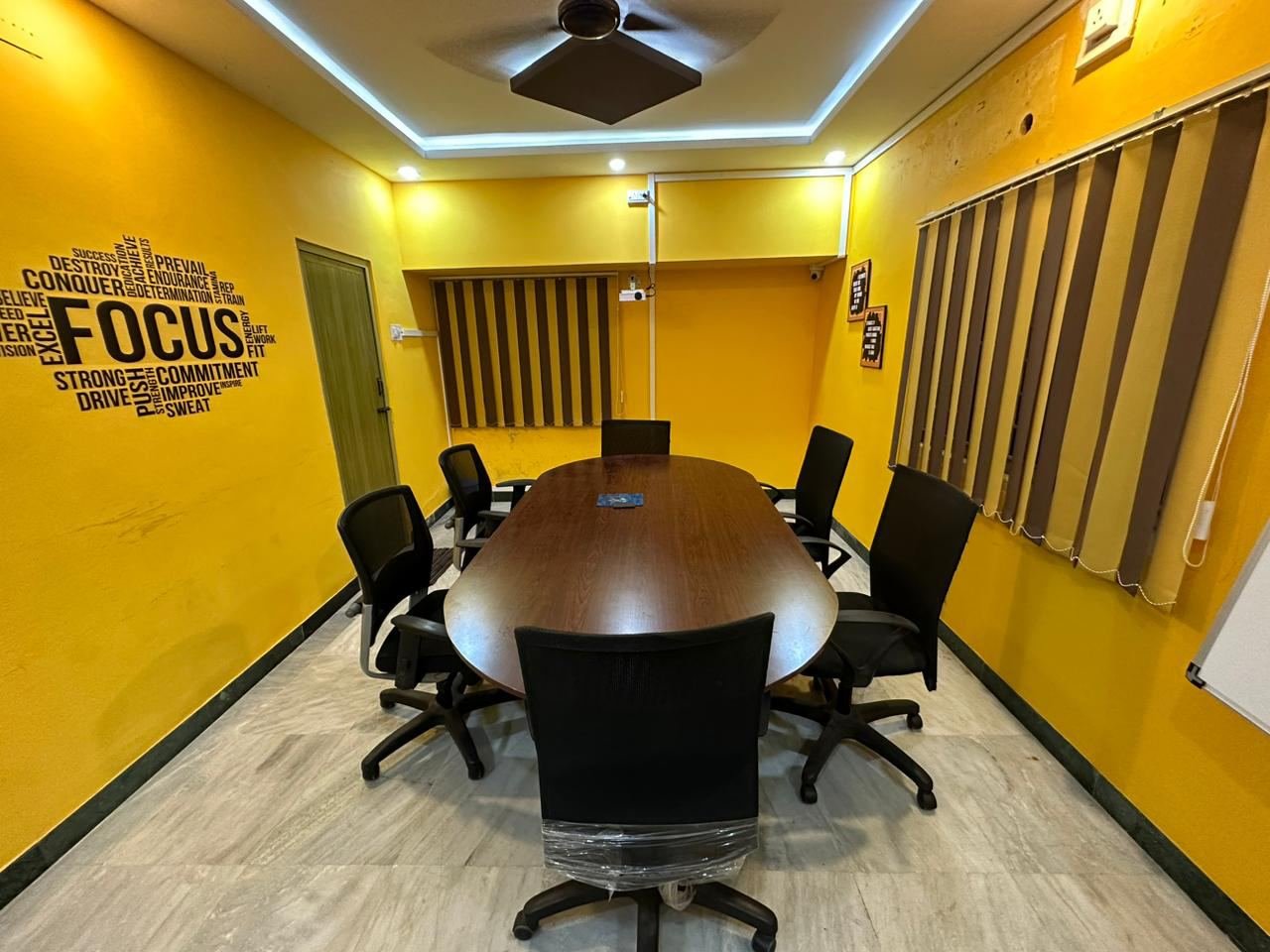 Break room with round tables and a coffee-themed mural
