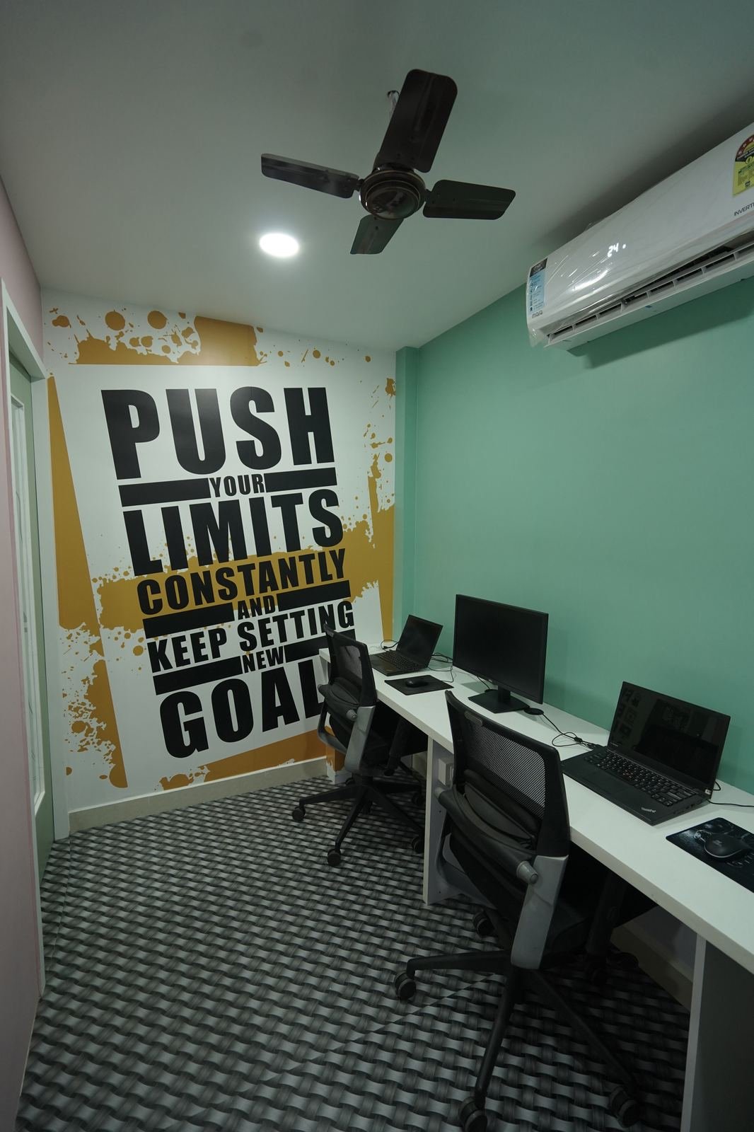 Workstation room with motivational posters on a mint wall
